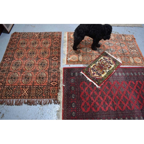 401a - A group of three Middle Eastern wool rugs, with geometric stylised borders together with a wool pray... 