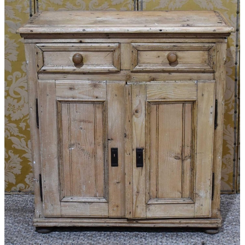 403 - An antique pine cabinet comprising two short drawers over two corresponding cupboard doors, raised o... 