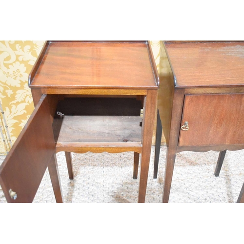 405 - A pair of 19th century mahogany bedside cabinets with single doors, shaped aprons and square tapered... 