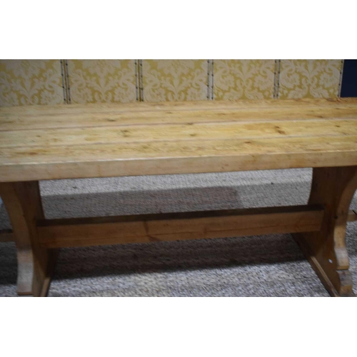 408 - A pine trestle table with thick four plank top, shaped end boards and plain single stretcher, 200 by... 