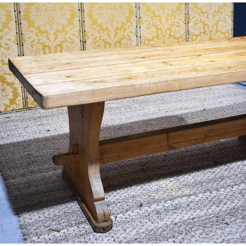 408 - A pine trestle table with thick four plank top, shaped end boards and plain single stretcher, 200 by... 