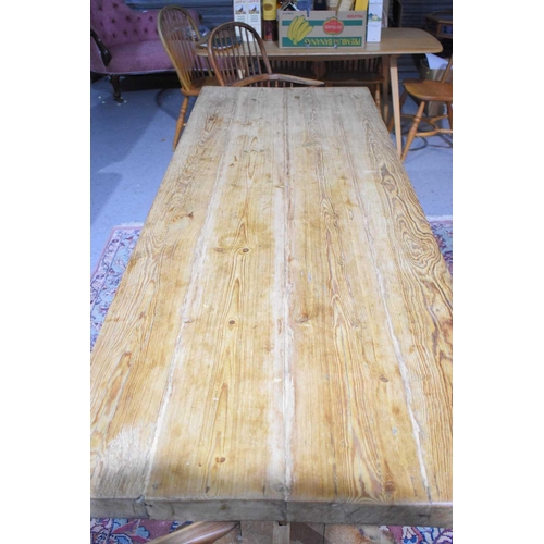 408 - A pine trestle table with thick four plank top, shaped end boards and plain single stretcher, 200 by... 