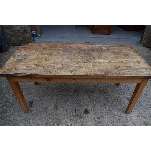 410 - An antique elm top kitchen table raised on square tapered legs, 77cm by 166cm by 74cm