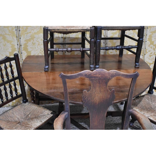 411 - An 18th century oak drop leaf table, the drop-leaf top on gate-leg action base with turned supports ... 