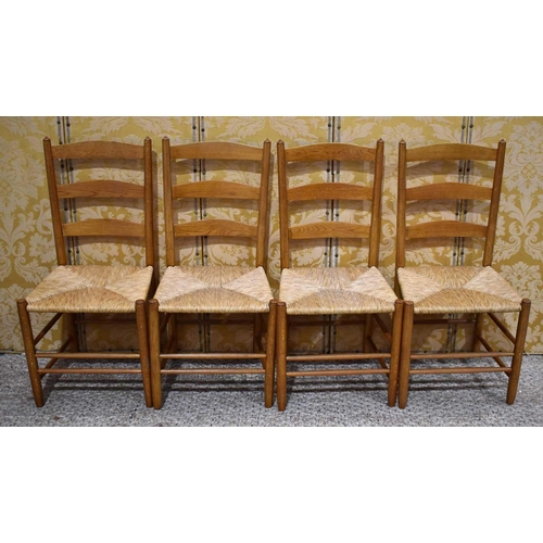 414 - A set of four Ernest Gimson Arts & Crafts movement rush seated ash ladder back chairs, 'The Bedales'... 