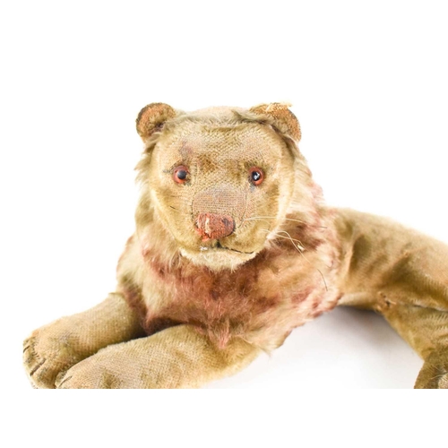 7 - A vintage Steiff lion, in recumbent position, A/F, 30cm long.