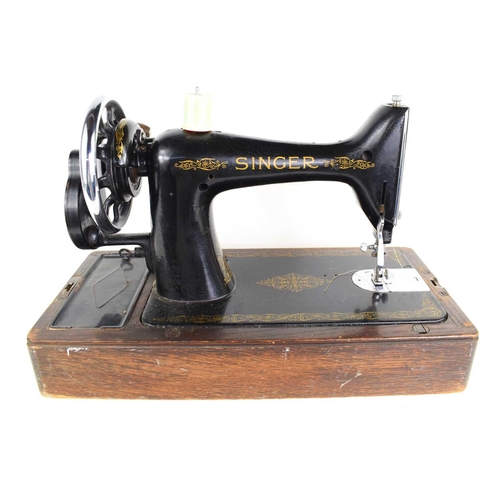 79 - A vintage Singer sewing machine with oak case.