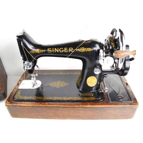 79 - A vintage Singer sewing machine with oak case.