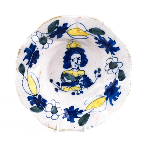 293 - A Dutch Delft Royal Commemorative dish, late 17th century painted in yellow, blue and green, with a ... 