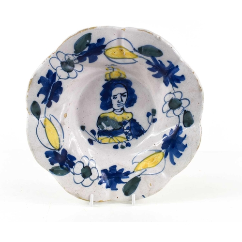 293 - A Dutch Delft Royal Commemorative dish, late 17th century painted in yellow, blue and green, with a ... 