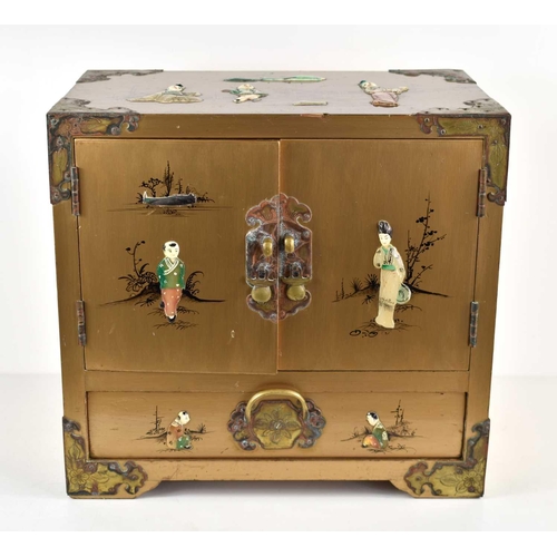 304 - A Chinese lacquered jewellery cabinet with hinged doors opening to three fitted drawers, with gilt m... 