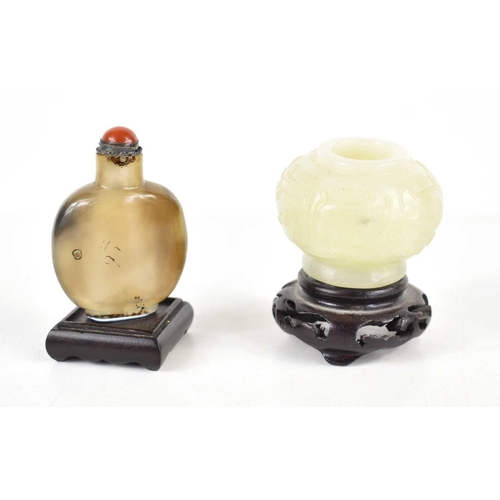 307 - A Chinese jade vase of small proportions, carved with foliage, together with a Chinese agate snuff b... 