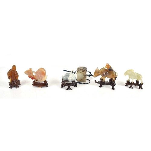 308 - A group of Chinese carved jade and agate animal figures to include a figure of a man riding a water ... 