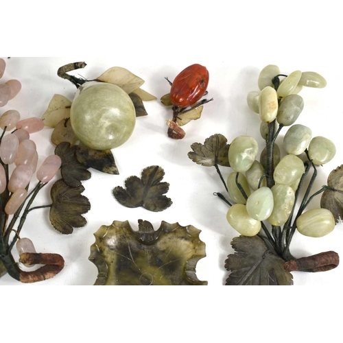 310 - A collection of Chinese carved jade and agate fruits to include grapes and apples together with a ca... 