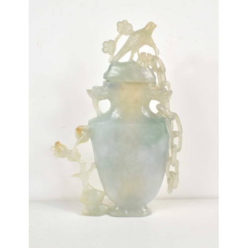 312 - A Chinese carved blue jade vase and cover, the cover attached to the body by a single chain and havi... 