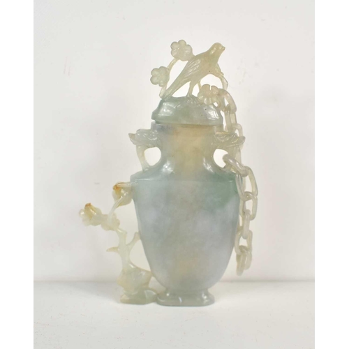 312 - A Chinese carved blue jade vase and cover, the cover attached to the body by a single chain and havi... 