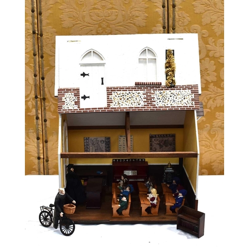 114 - A vintage dolls house modelled as a school, the lift up folding front opening to reveal a single roo... 
