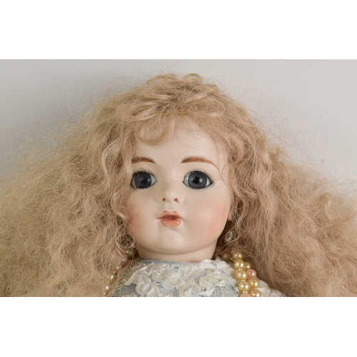 87 - A Divina Collection porcelain bisque head doll, wearing a blue silk and lace dress, 07 / 01 to the b... 