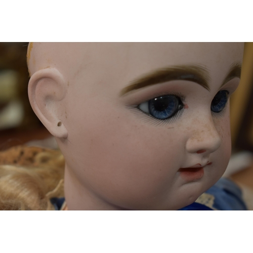 130 - A vintage Kestner doll with bisque socket head impressed 'R4D', heavy feathered brows, blue glass sl... 