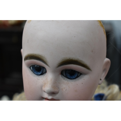 130 - A vintage Kestner doll with bisque socket head impressed 'R4D', heavy feathered brows, blue glass sl... 