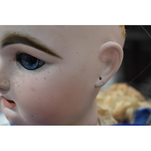 130 - A vintage Kestner doll with bisque socket head impressed 'R4D', heavy feathered brows, blue glass sl... 