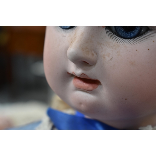 130 - A vintage Kestner doll with bisque socket head impressed 'R4D', heavy feathered brows, blue glass sl... 