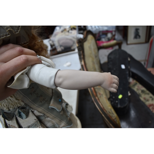 88 - A German porcelain bisque head doll, with composition body and articulated arms.