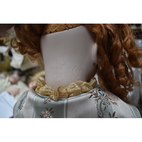 88 - A German porcelain bisque head doll, with composition body and articulated arms.