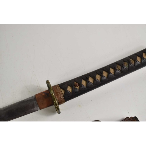 110 - A WWII era Japanese officers Shin Gunto Katana, the 68cm steel blade with undulating hamon, signed t... 