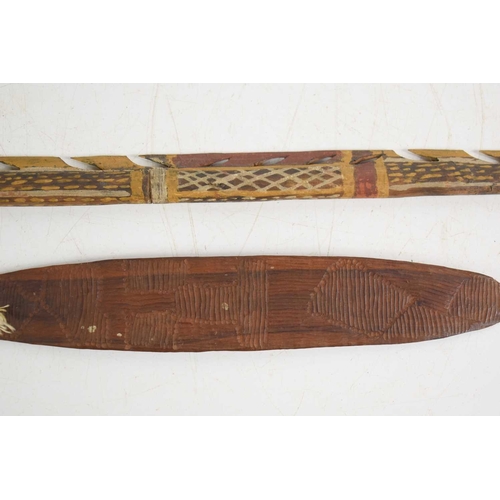 115 - An aboriginal barbed painted spear, 80cm, together with an aboriginal engraved bullroarer, 29cm long... 