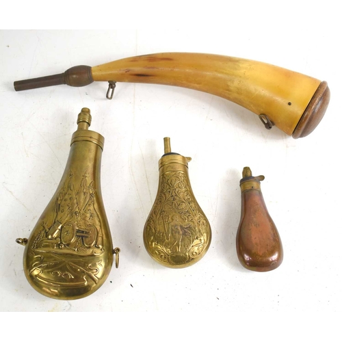 116 - A group of powder flasks to include a brass Colt Walker type embossed with flags and arms with cross... 