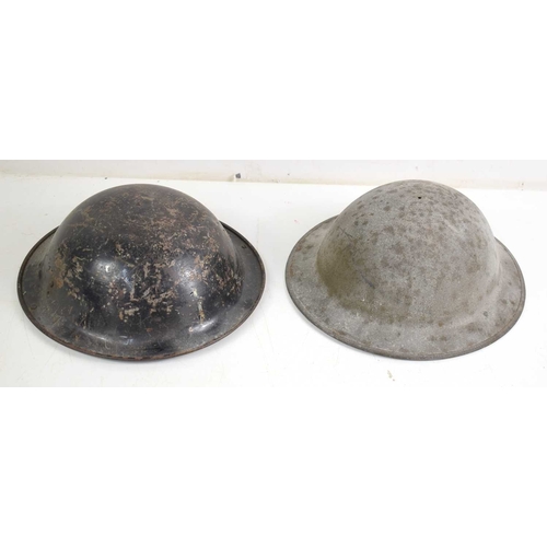 117 - Two steel Brodie helmets, one having the original liner.