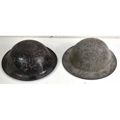 117 - Two steel Brodie helmets, one having the original liner.