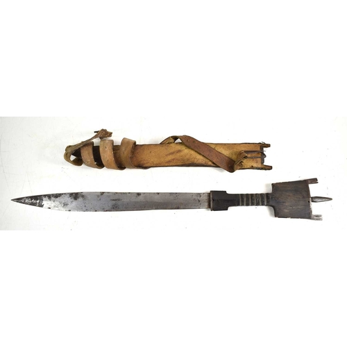 65 - A Somalian Billao dagger or short sword, with tapering blade and metal-inlaid horn handle with tripl... 