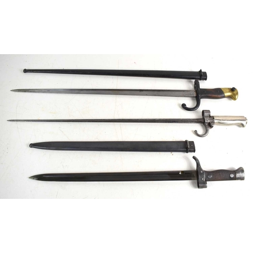 70 - A group of bayonets to include a French 1892 pattern bayonet with scabbard, a French 1874 pattern Gr... 