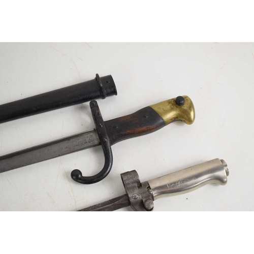 70 - A group of bayonets to include a French 1892 pattern bayonet with scabbard, a French 1874 pattern Gr... 