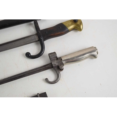 70 - A group of bayonets to include a French 1892 pattern bayonet with scabbard, a French 1874 pattern Gr... 