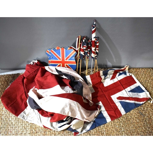 76 - A group of 1940s and later Union Jack flags, the largest measuring 150cm by 194cm.