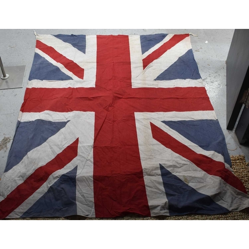 76 - A group of 1940s and later Union Jack flags, the largest measuring 150cm by 194cm.