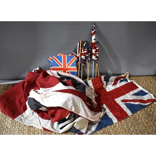 76 - A group of 1940s and later Union Jack flags, the largest measuring 150cm by 194cm.