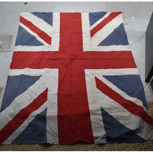76 - A group of 1940s and later Union Jack flags, the largest measuring 150cm by 194cm.