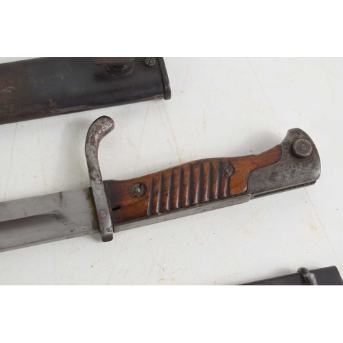 77 - A French 1892 pattern bayonet with scabbard, numbered 67612, together with a German model M1898/05 “... 