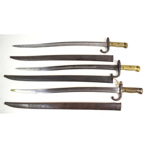 81 - A group of three French model 1866 Chassepot sword bayonets with Yataghan recurved T form blade, wit... 