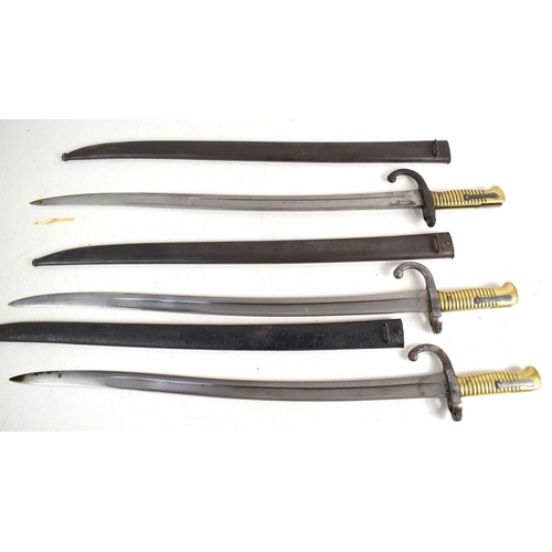 87 - A group of three French model 1866 Chassepot sword bayonets with Yataghan recurved T form blade, one... 