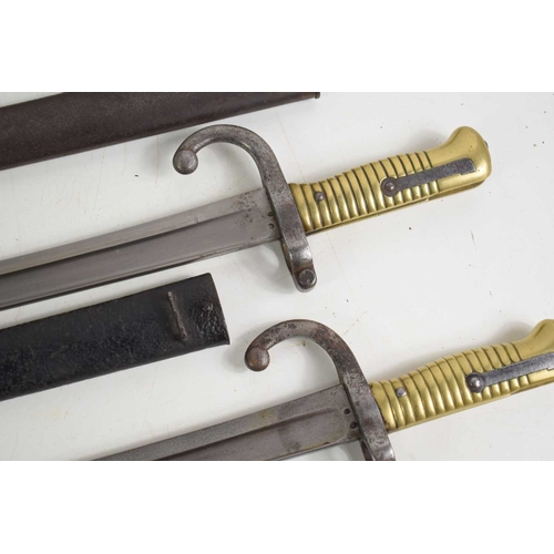 87 - A group of three French model 1866 Chassepot sword bayonets with Yataghan recurved T form blade, one... 