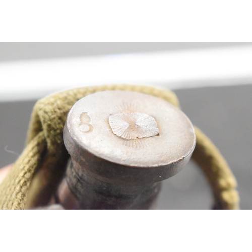 71 - A US WWII era M3 fighting knife, the hilt stamped with the flaming bomb proof mark, house in a US M8... 