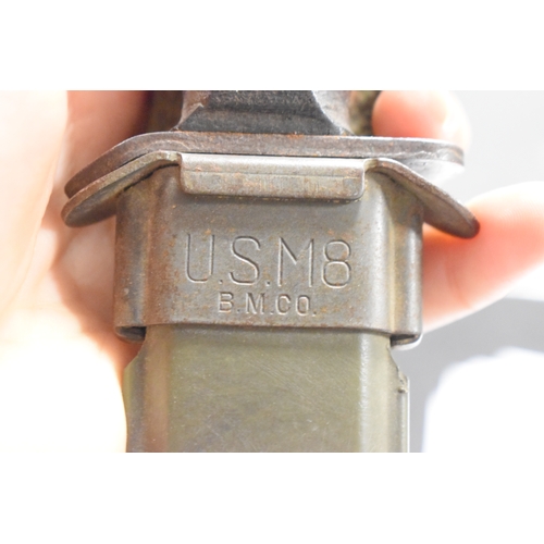 71 - A US WWII era M3 fighting knife, the hilt stamped with the flaming bomb proof mark, house in a US M8... 