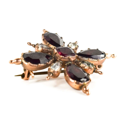 11 - A Georgian gold plated brooch, of starburst form, inset with garnets and white paste, foil backed, 4... 