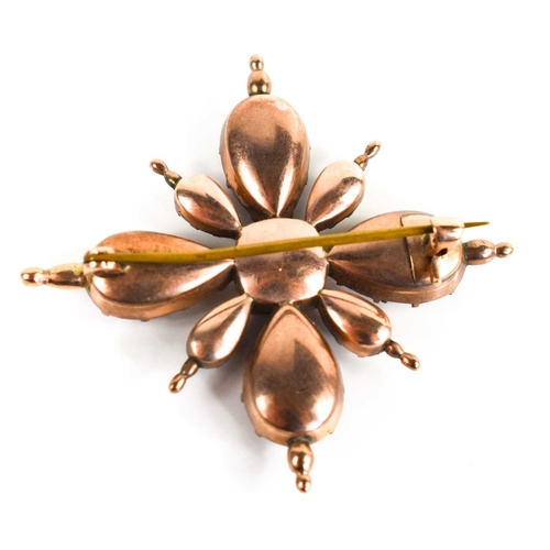 11 - A Georgian gold plated brooch, of starburst form, inset with garnets and white paste, foil backed, 4... 