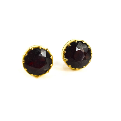 12 - A pair of 9ct gold and garnet stud earrings, old European cut in enclosed setting, with butterfly ba... 